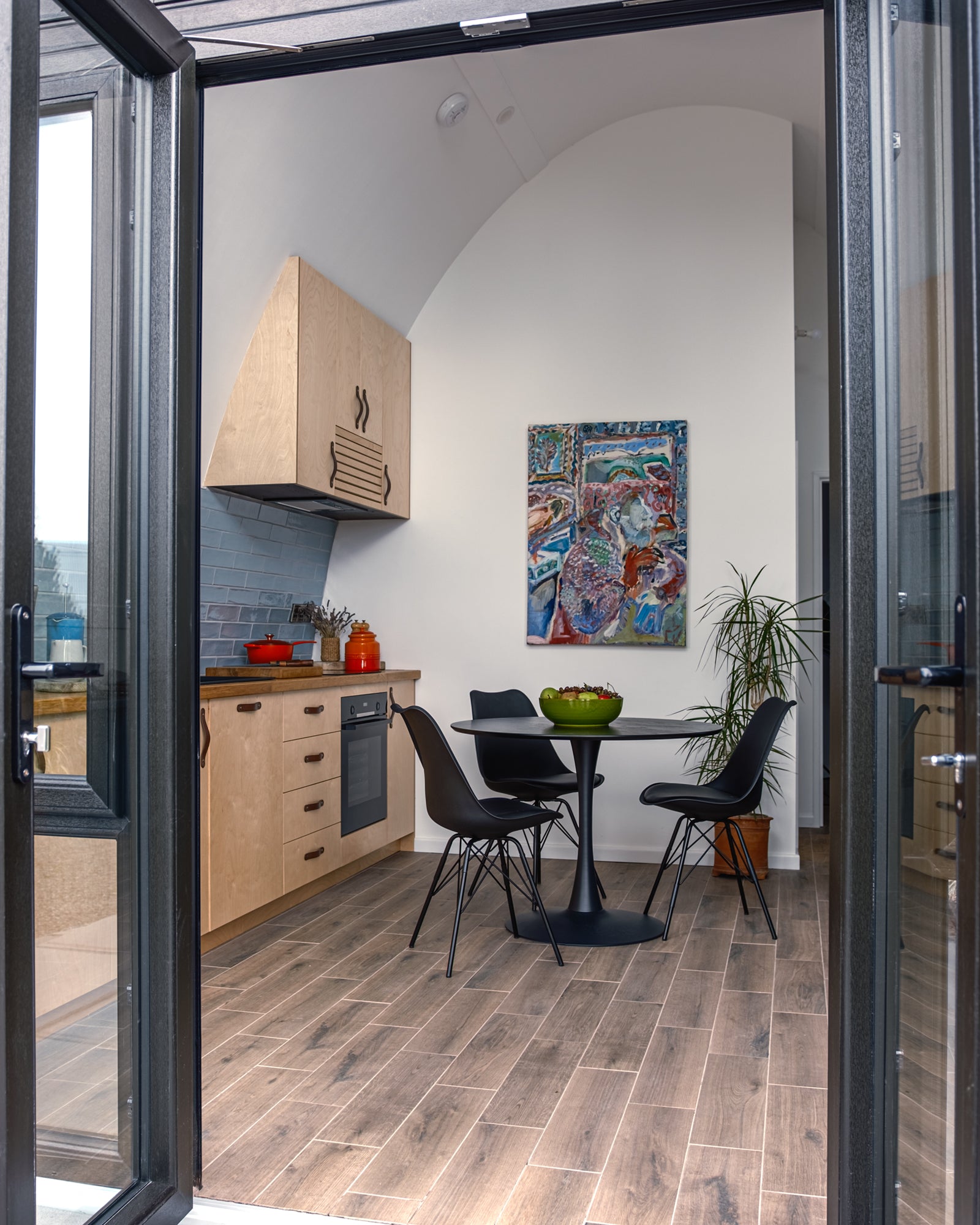 Interior of the Aviator Lodge modular home showing the kitchen and the high curving wall.