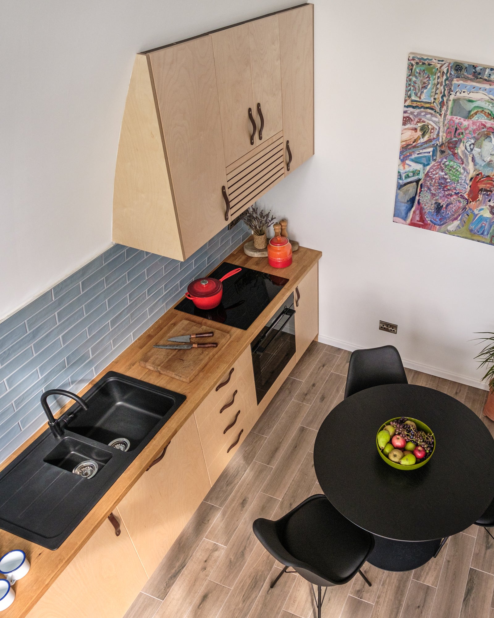 Full kitchen in the Aviator Haus modular home with wall cabinet mounted on the curving wall.