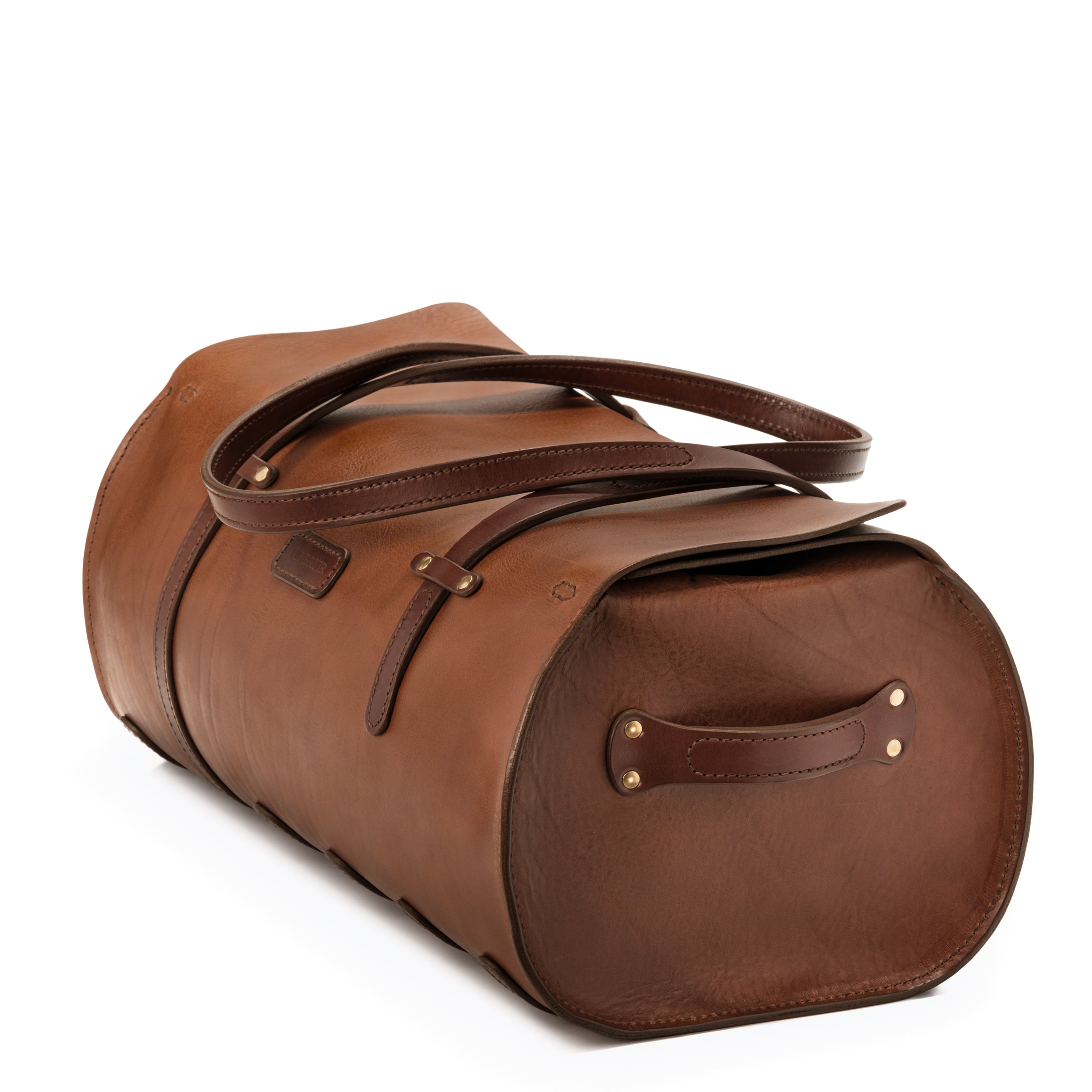 Photo showing the leather end grab handle of the Duffle bag. The chunky stitched handle is riveted on to the end panel of the Bag.
