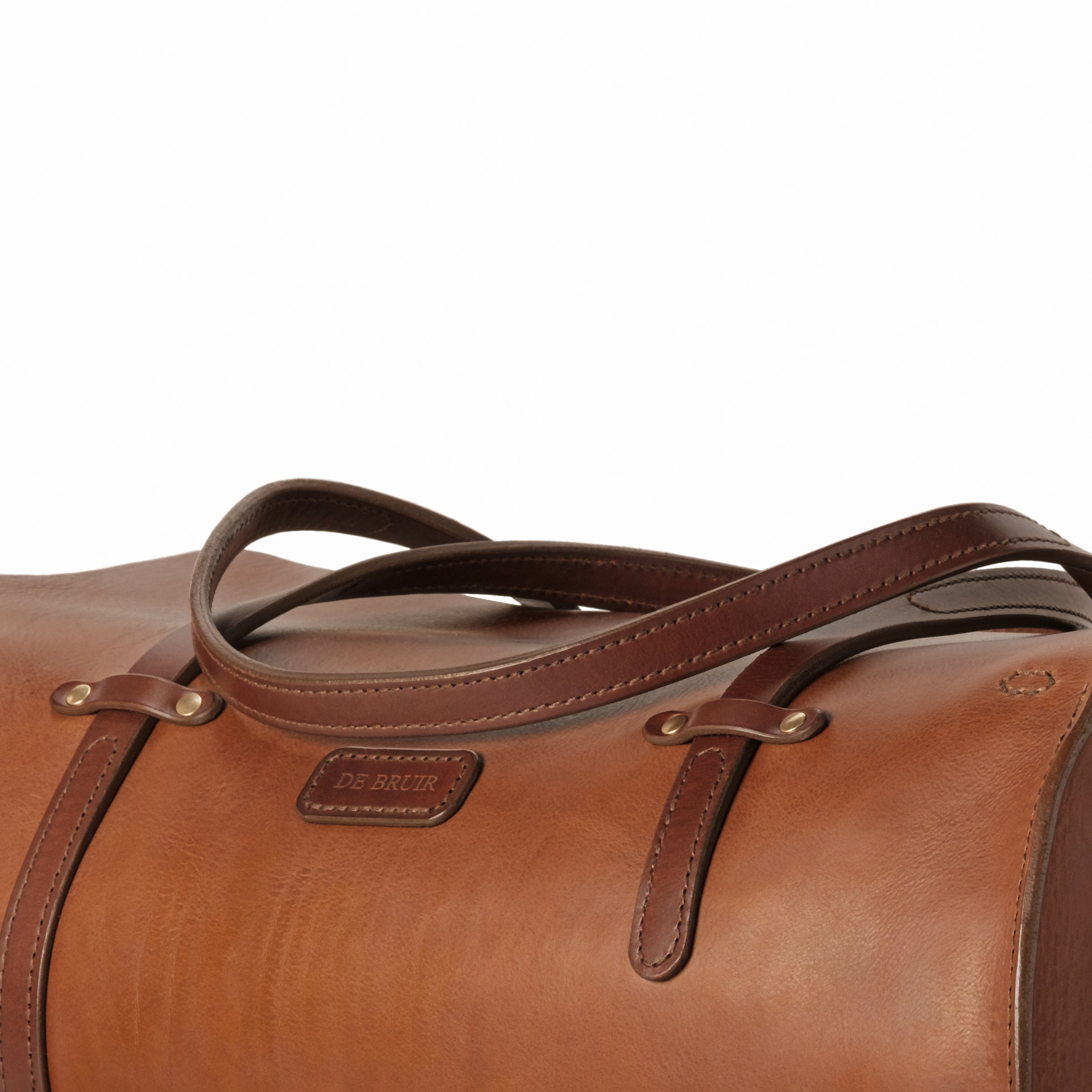 Handmade in Ireland, this Duffle Bag features a strong bridle leather throughout. Stitching is on a heavy duty Singer 45 sewing machine. Complimented by saddle stitch details are in a wax linen thread.