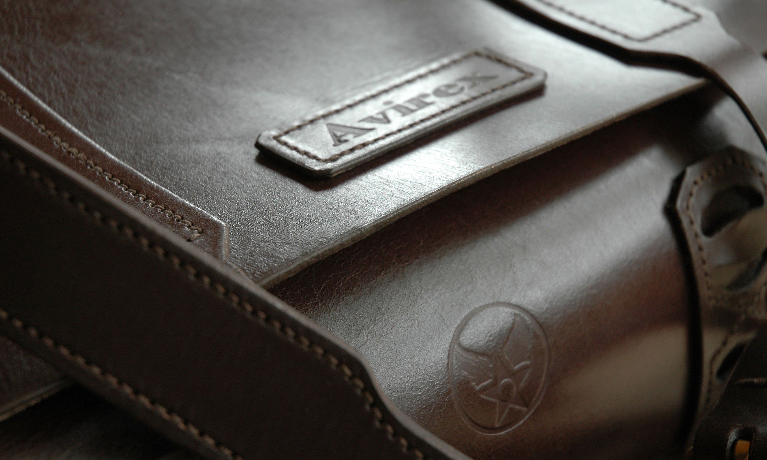 Detail of a leather bag with 'Avirex' branding that was handmade by Garvan de Bruir.