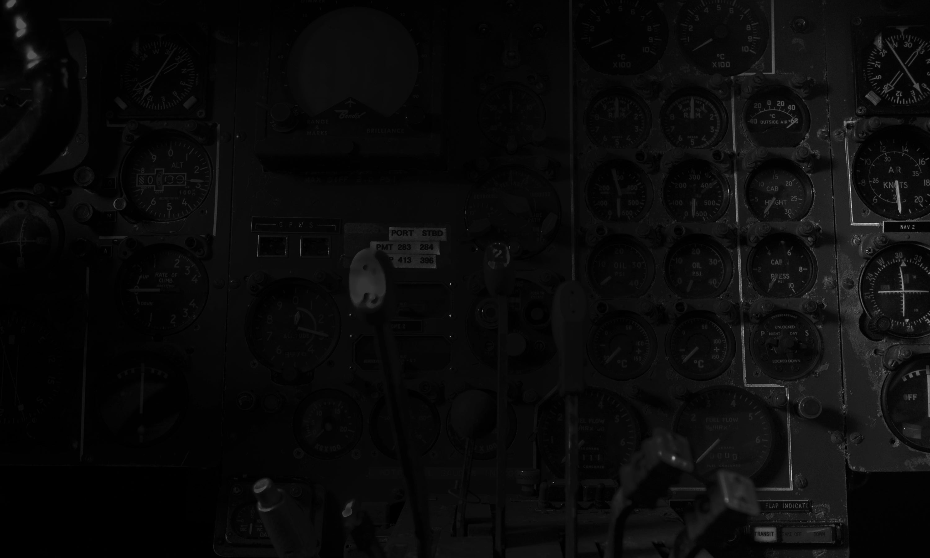 Close-up of a vintage aircraft cockpit with various dials and switches. Backdrop for Aviation Bags at the DE BRUIR Atelier.