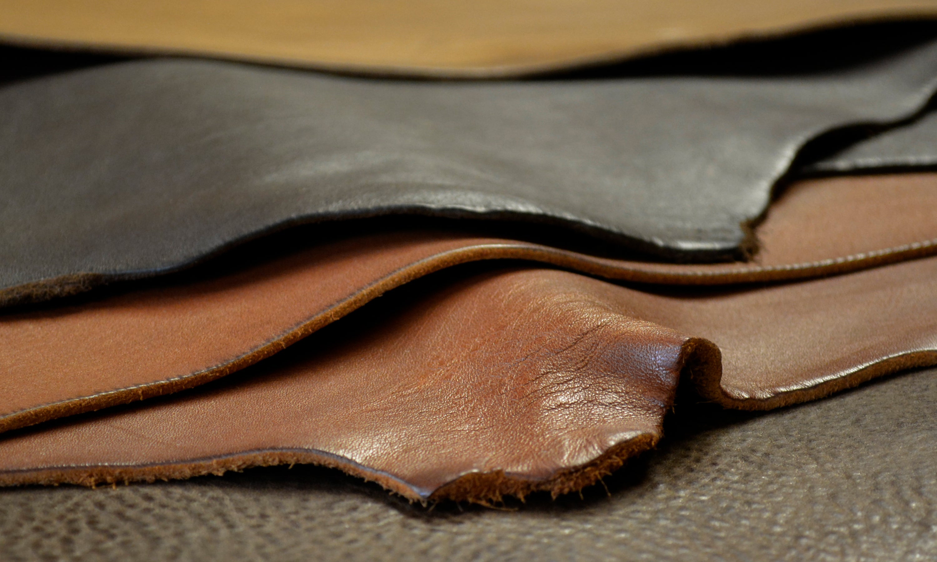 Rich colours of leather hides on the workbench in the DE BRUIR Atelier in Kildare Ireland. Waiting to be made into classic travel bags by Garvan de Bruir.