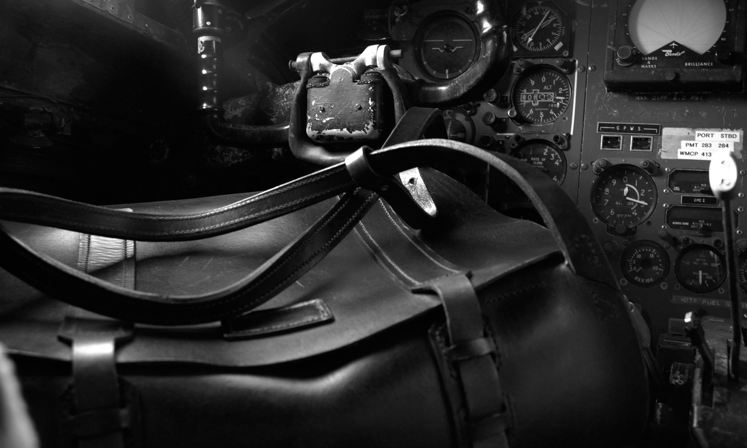 An image of an original Garvan de Bruir leather Backpack in the cockpit of a vintage fighter aircraft.