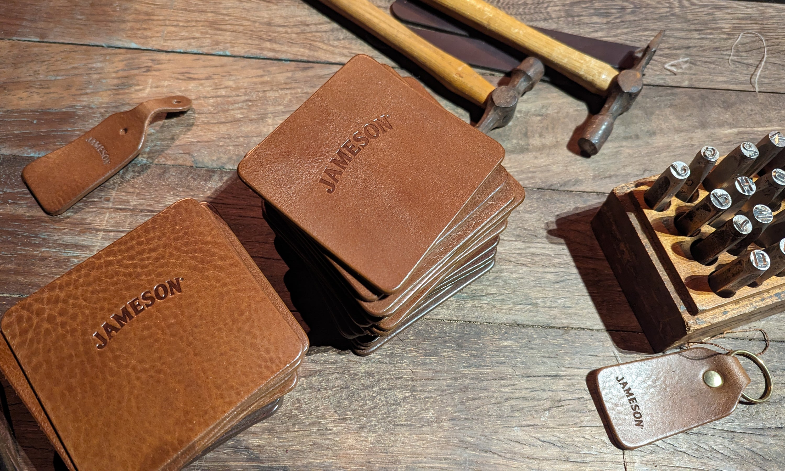 Handcrafted leather coasters with Jameson logo embossed for corporate event gifting in Dublin using embossing tools