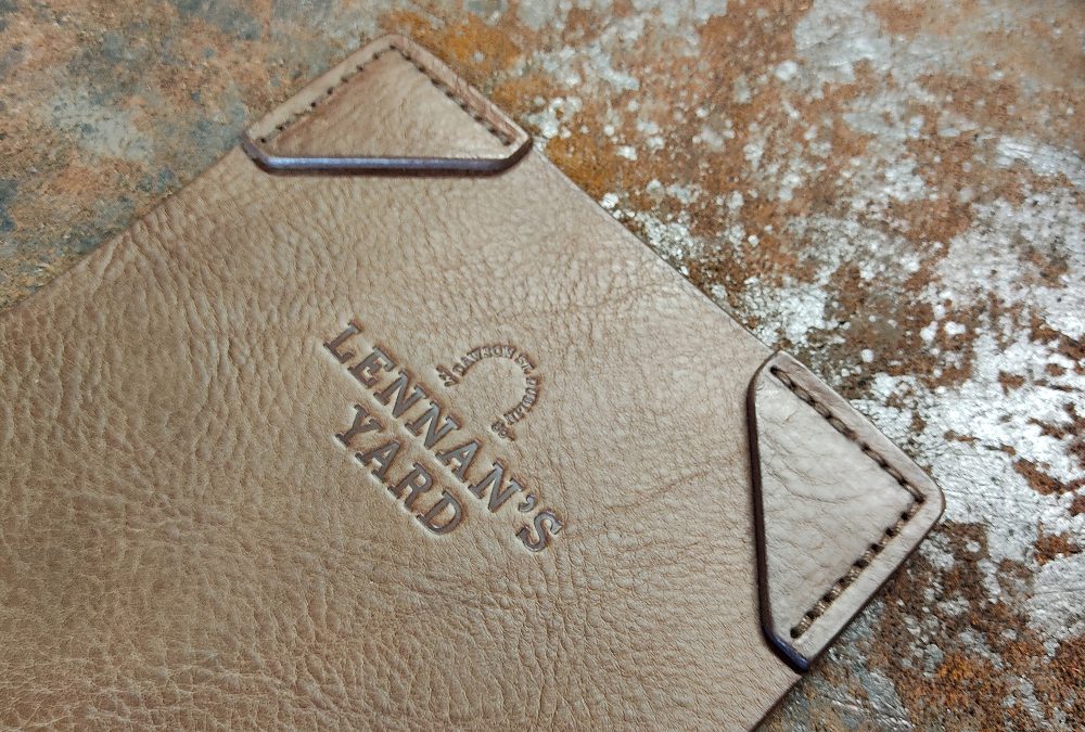 Custom handcrafted full-grain leather menu booklet and bill covers with embossed restaurant logo for a hospitality commission in Dublin
