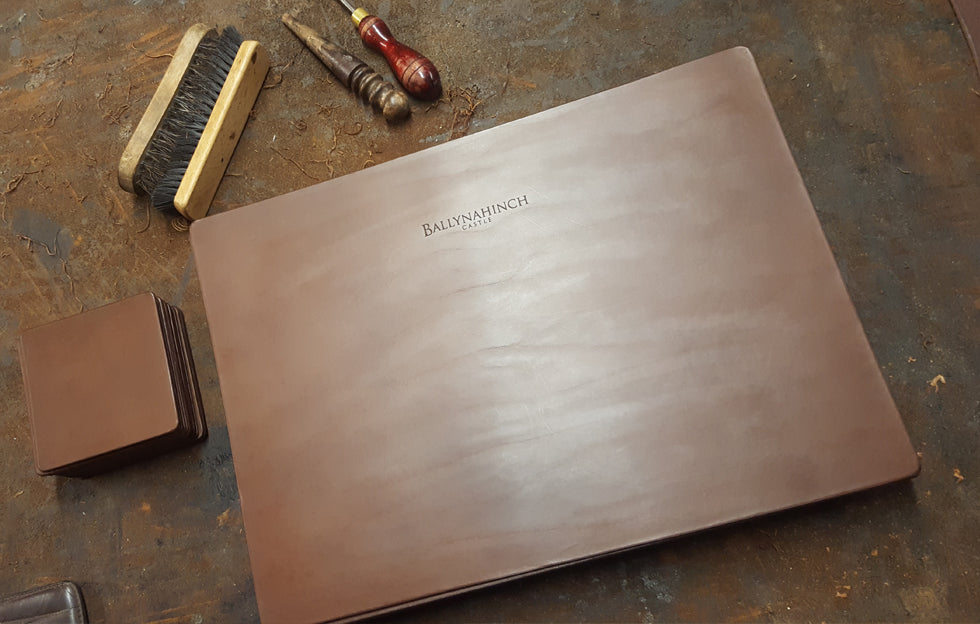 Custom handcrafted full-grain leather placemats and coasters embossed for Ballynahinch Hotel as a luxury hospitality commissio Ireland