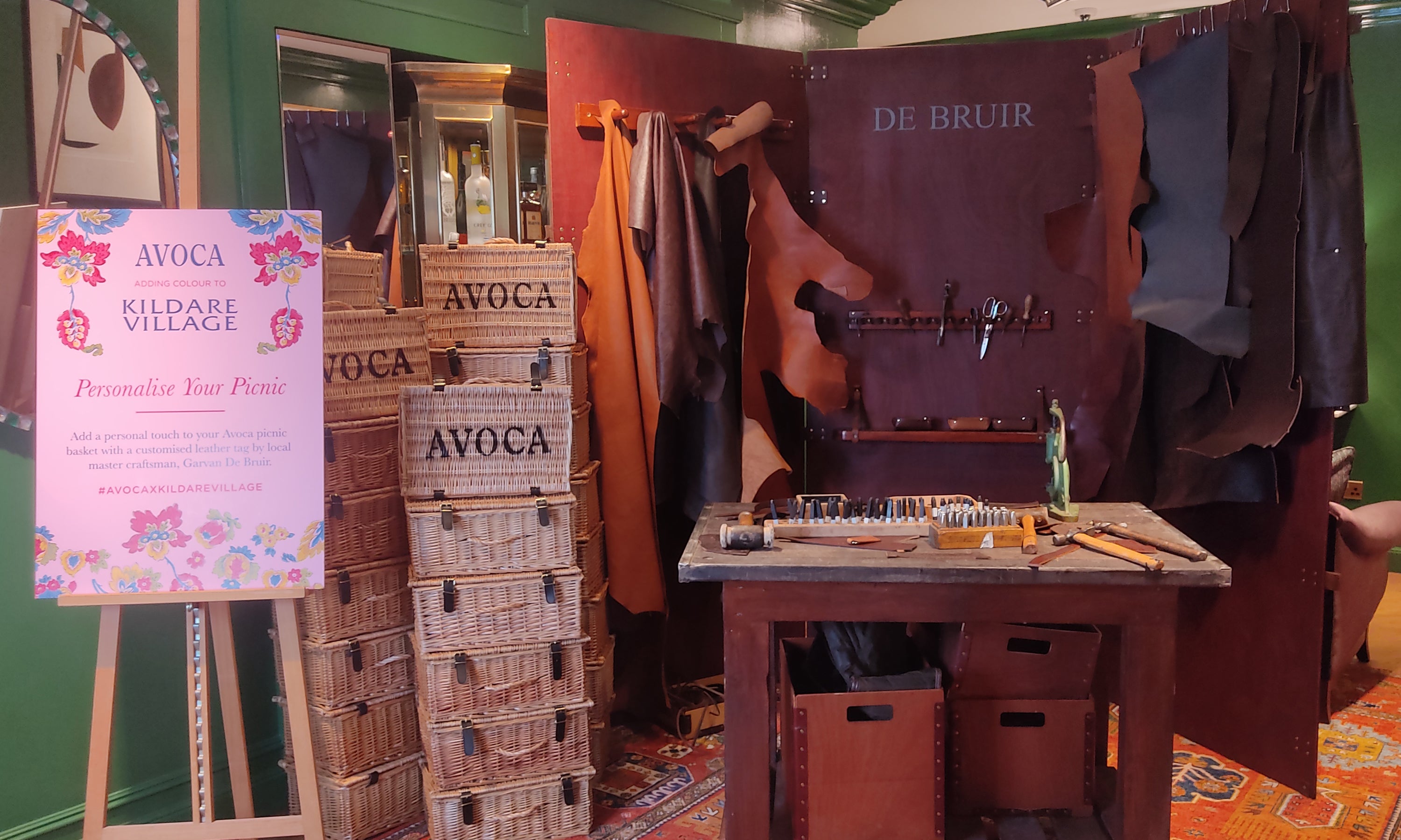 De Bruir pop-up handcrafted Irish leather workshop at Avoca Kildare Village personalising picnic baskets with custom embossing for corporate gifts
