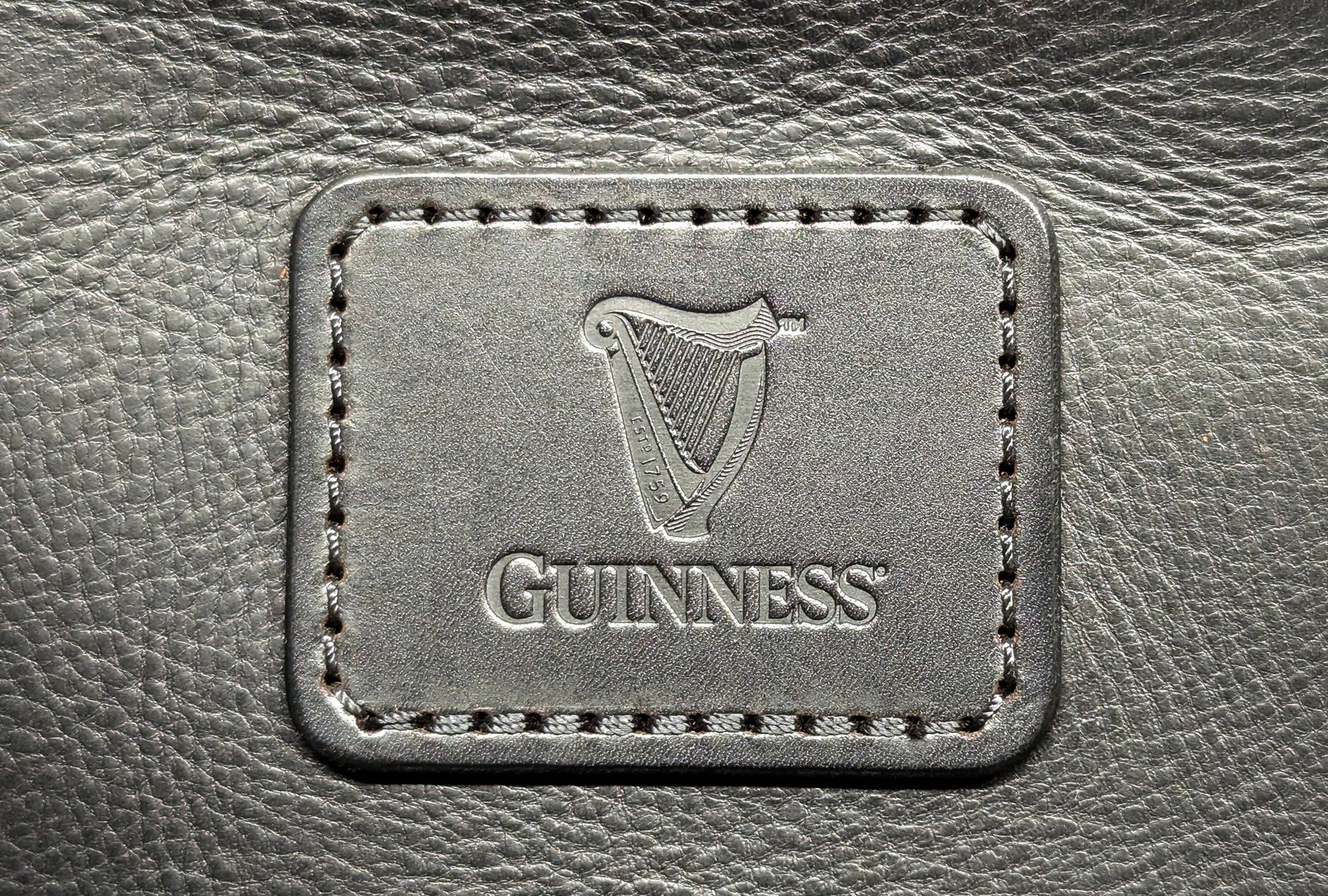 Embossed Guinness logo on handcrafted leather bag