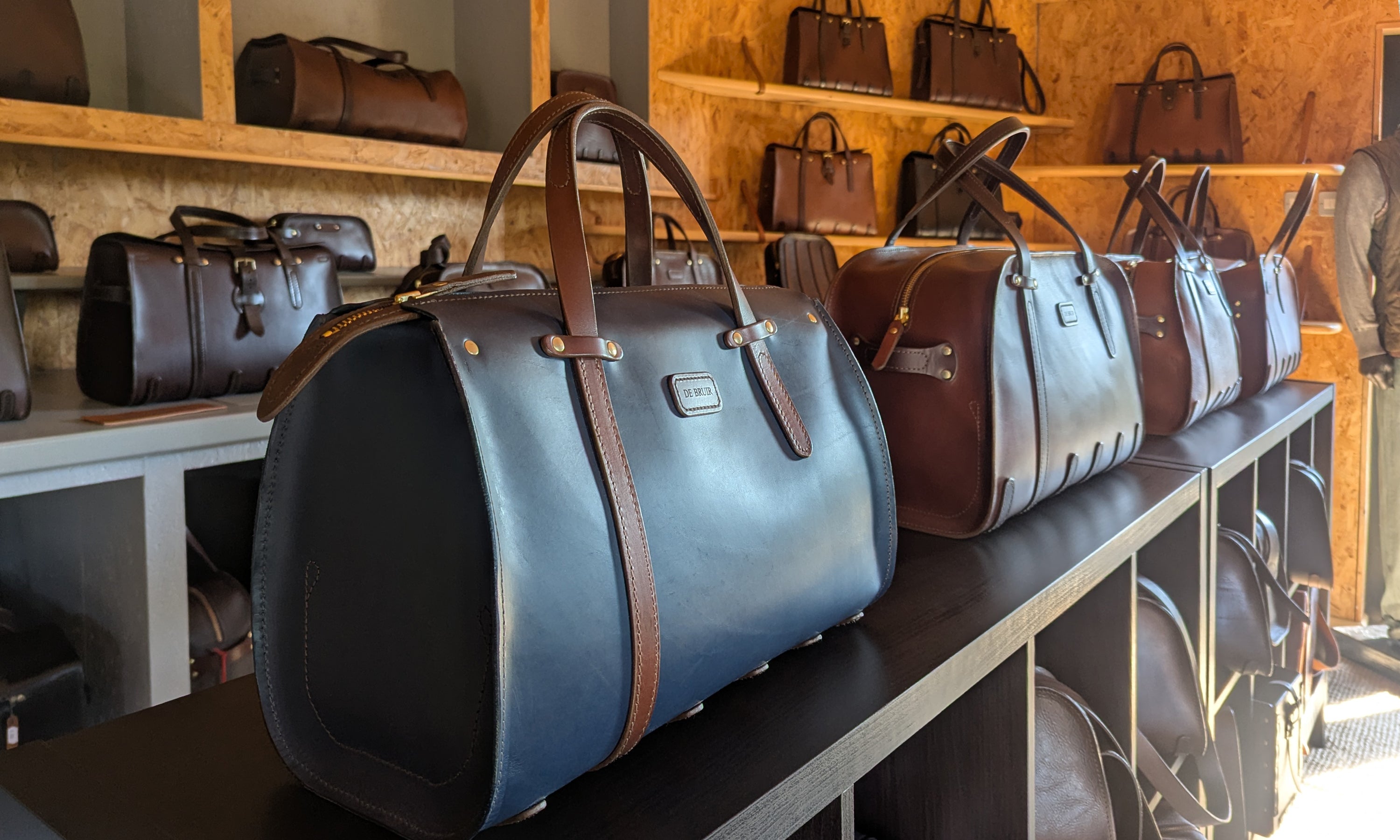 Collection of handcrafted leather bags by Garvan de Bruir showcased on display in retail showroom