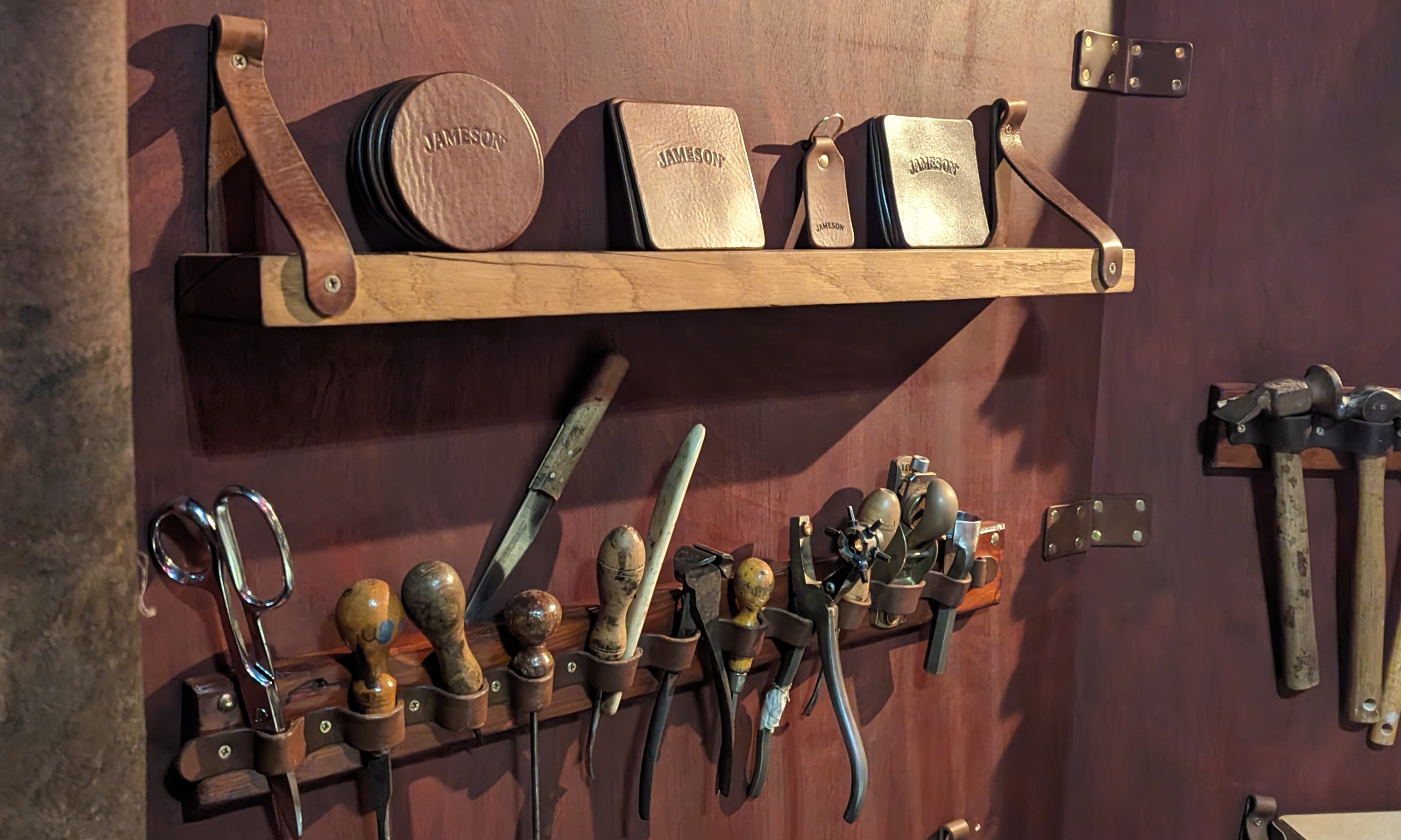 Leather craft tools and branded coasters with Jameson logo at a handcrafted Irish corporate event workshop in Dublin for middleton black barrel