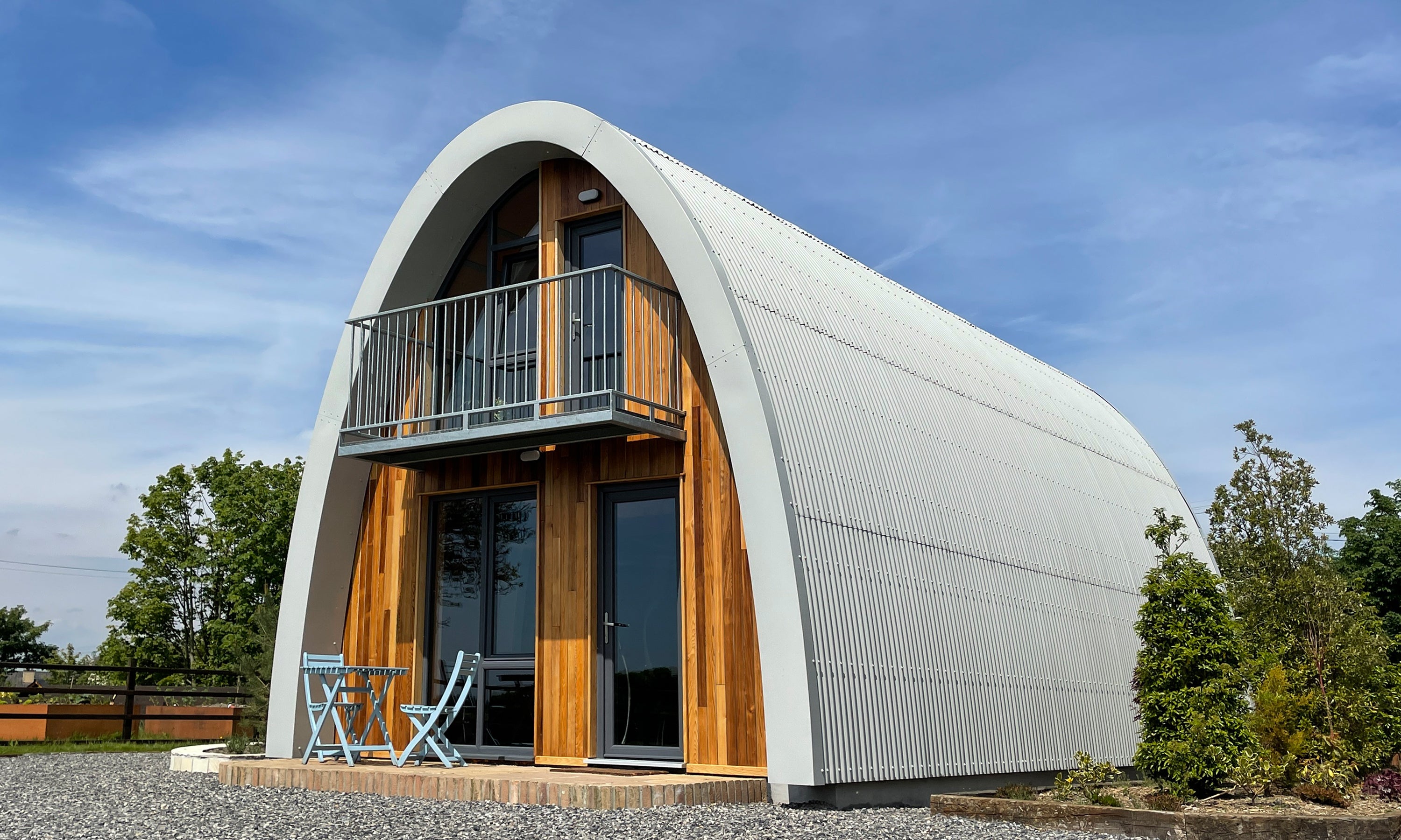 Aviation inspired timber building with a curved roof. Contemporary prefab architecture by Garvan de Bruir. 