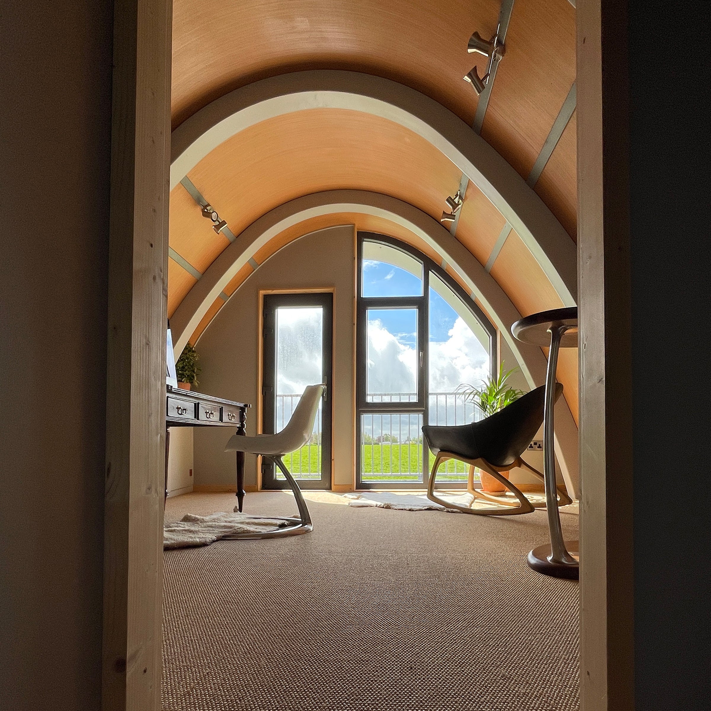 Contemporary curved roof interior of the Aviator House. Inspired by the plywood aircraft the deHavilland Mosquito.
