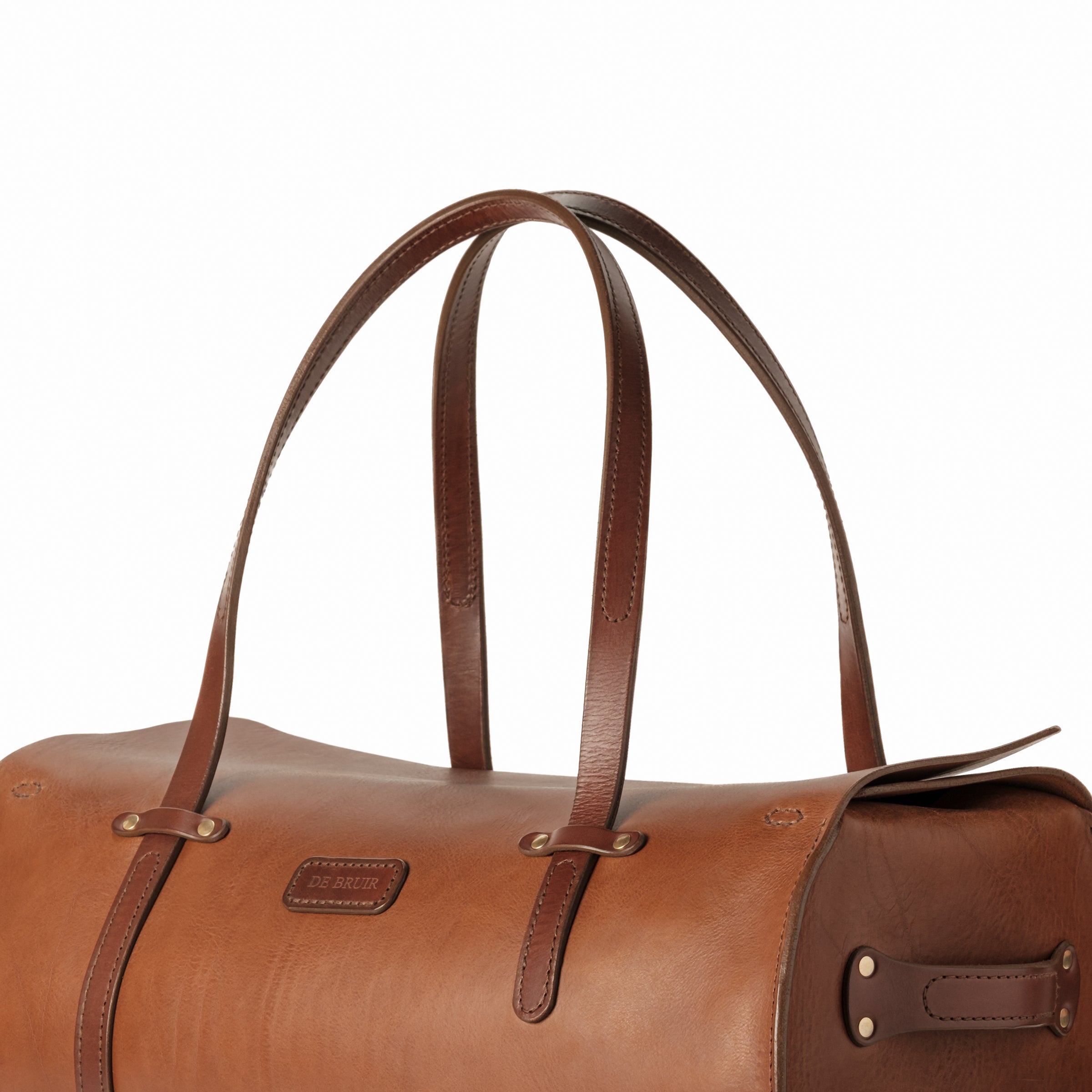 Detail of the long leather handles of the DE BRUIR Duffle Bag. Featuring a combination of stitching by a 'Singer 45 sewing machine' and 'saddle stitching' by hand. 