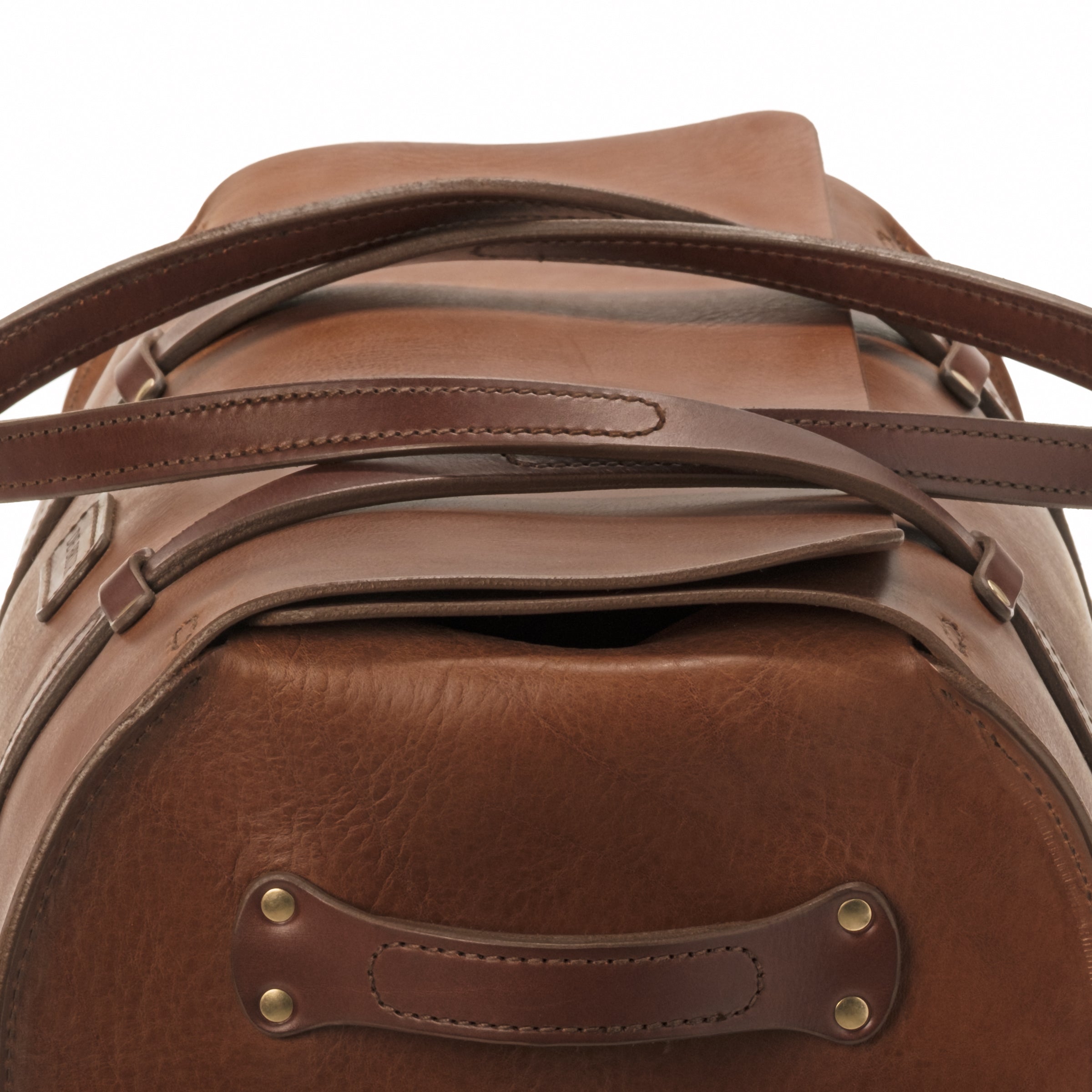 And end view of the DE BRUIR leather Duffle Bag shows how the large portion of bridle leather overlaps itself to close the bag.  