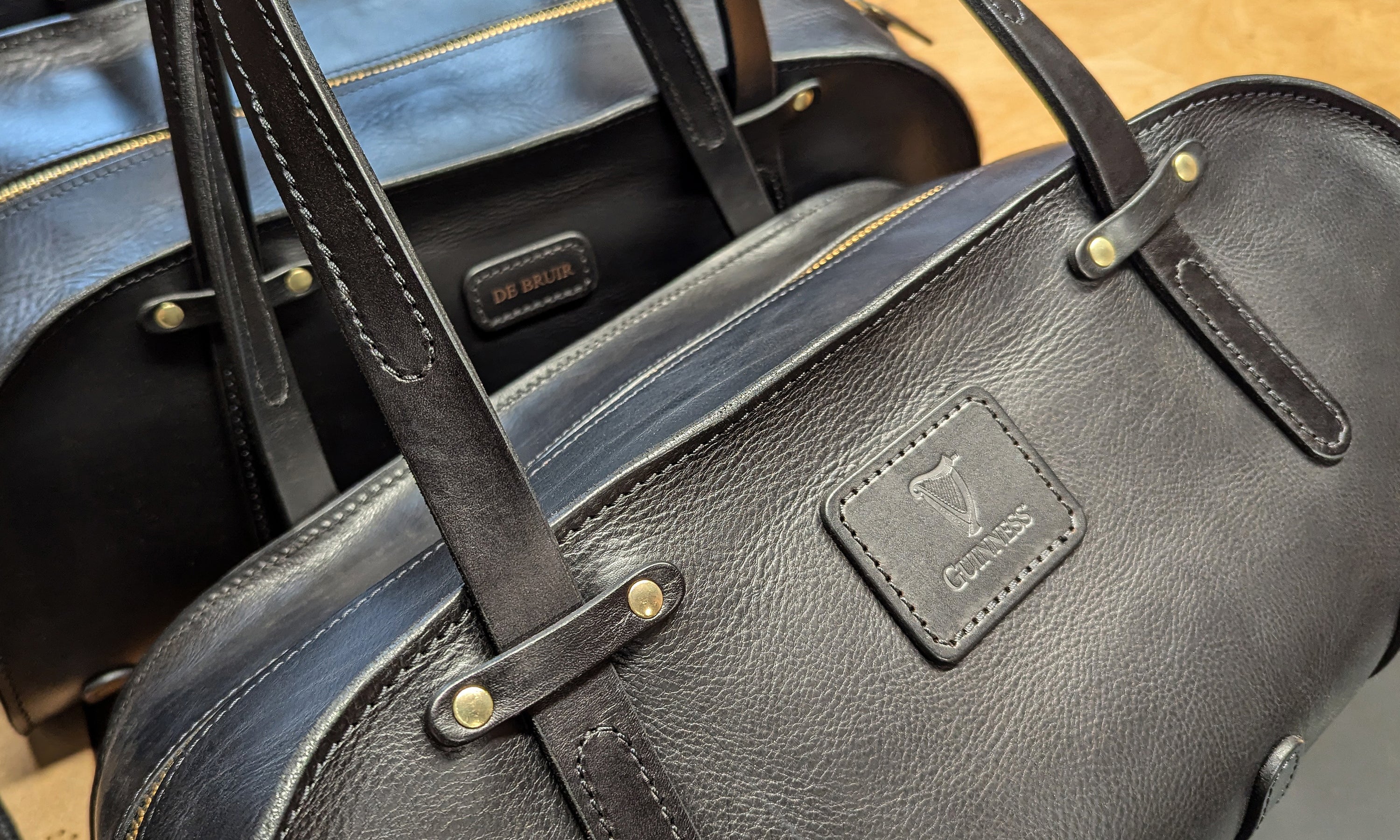 A handmade leather Sports Bag by Garvan de Bruir. Customised with the Guinness logo embossed on the front patch. Handmade in Ireland.  