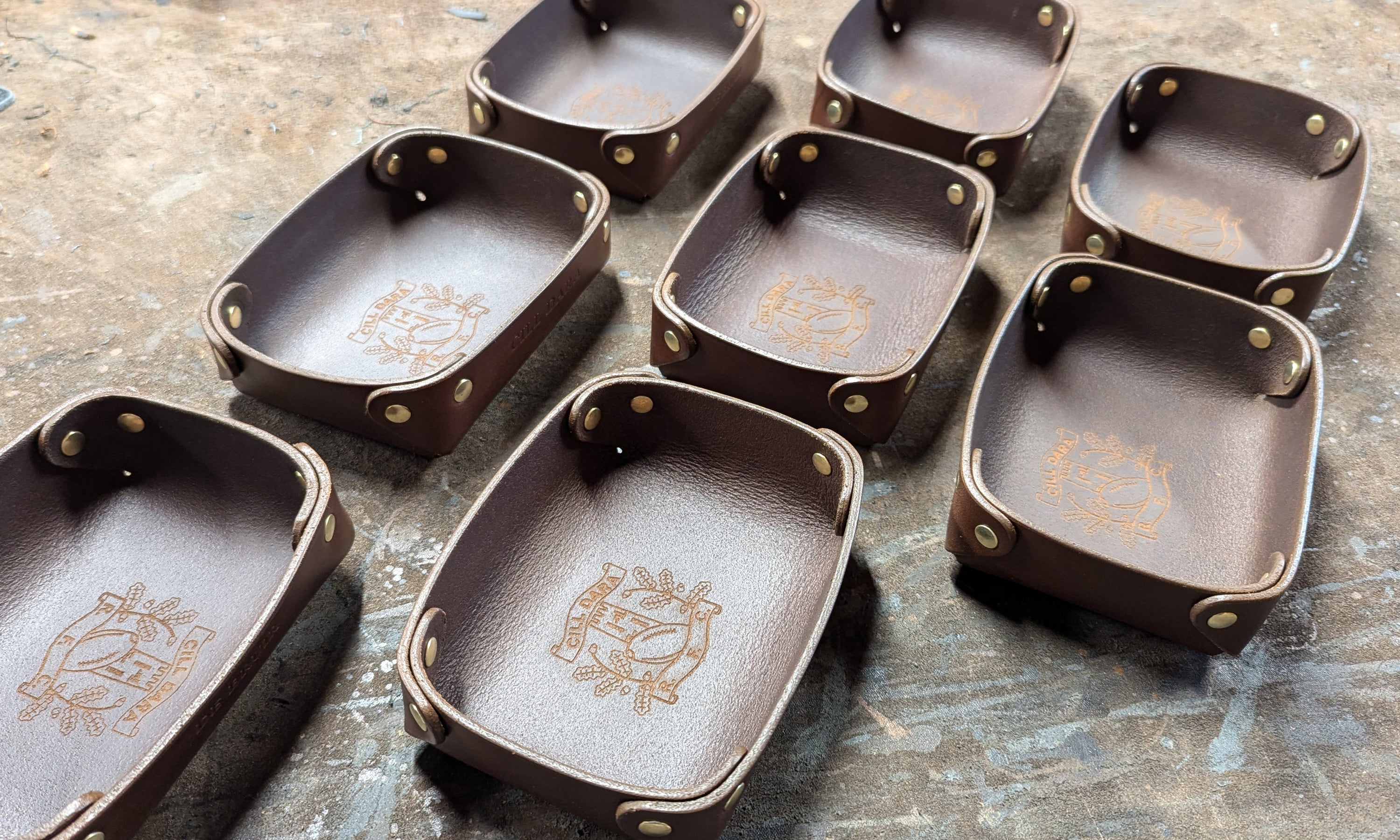 Set of brown leather trays with lazer engraved kildare rugby club logos 