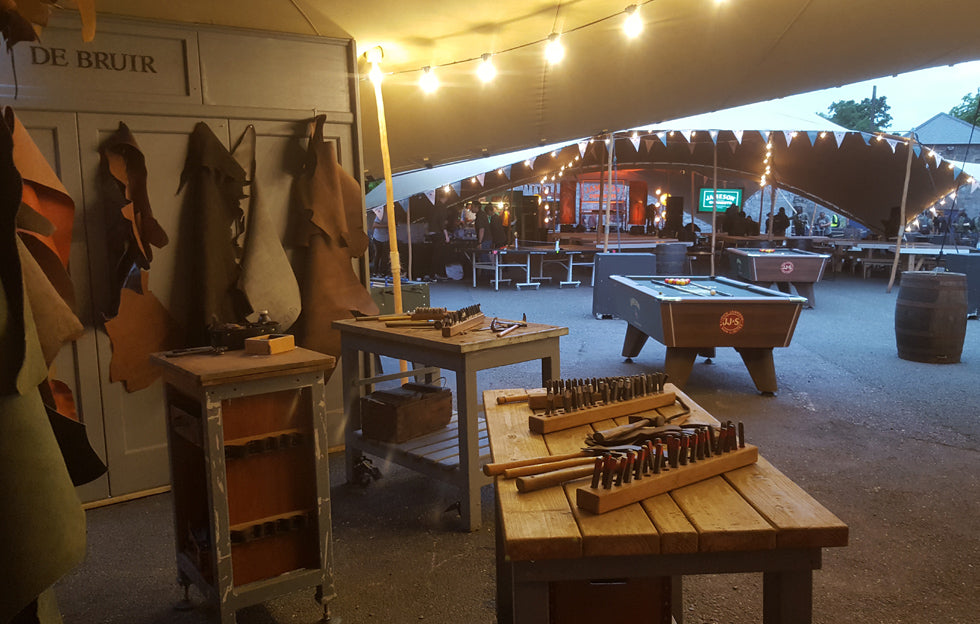De Bruir pop-up handcrafted Irish leather workshop at a Jameson corporate event in Dublin with embossing tools and materials ready for guests