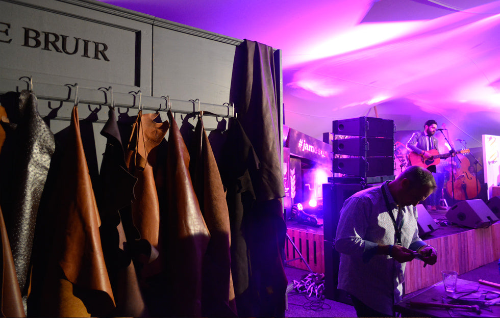 Handcrafted Irish leather workshop with live music at a corporate event in Dublin, featuring De Bruir leather display and guests creating personalised bracelets
