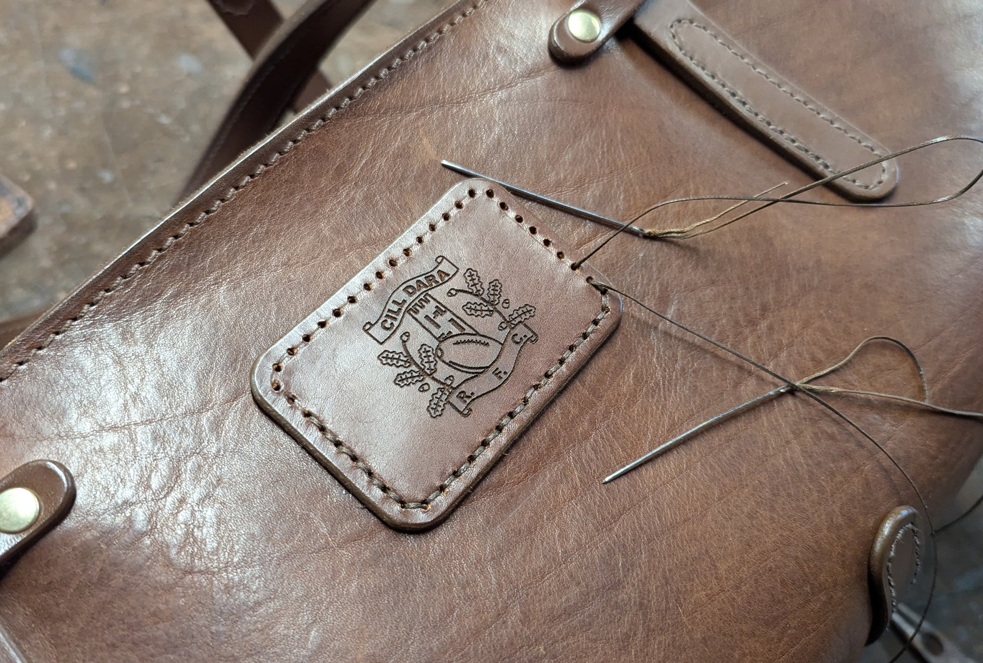 Hand-stitched Irish handmade leather bag with Kildare Rugby Club engraving for custom gifts