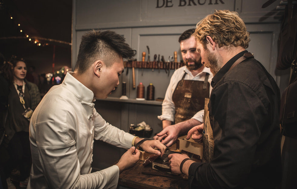 Garvan de Bruir guiding guests creating leather bracelets during an interactive corporate workshop in Jameson Distillery in Dublin