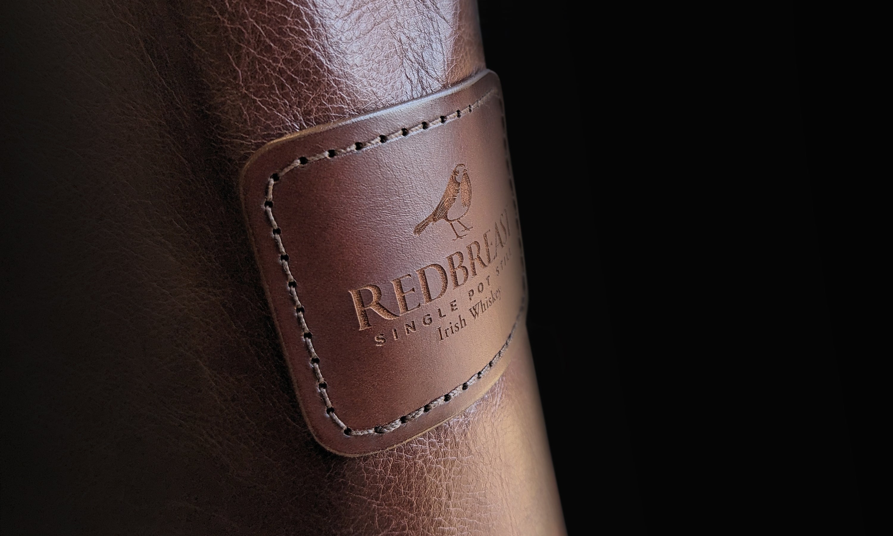 Irish handmade leather bottle cover with Redbreast branding for luxury corporate gifts